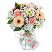 Freshly arranged with care, this bouquet from Bexley's heart radiates soft romance and uplifting energy. Swirling peach-pink roses open at the arrangement's center, their petals velvety and inviting, accompanied by two glowing peach-orange gerbera daisies whose bold petals and dark centers shine with cheer. Scattered sprays of pure white gypsophila fill the spaces with cloudlike lightness, while small white chrysanthemums with tart green centers offer both softness and playful contrast. Subtle eucalyptus branches-deeply green and faintly fragrant-emerge between the blooms, providing textural interest and local character. Everything is arranged in a clear glass vase, the tangle of green stems and clear water visible below, all topped by a bow of rustic twine. Suspended from the bow, a blank white tag is ready to bear a handwritten note-perhaps marking a Bexley baby's arrival, a heartfelt thank you, or a birthday surprise. This arrangement embodies the gentle elegance and neighborly warmth of Bexley, perfect for brightening any room or occasion.